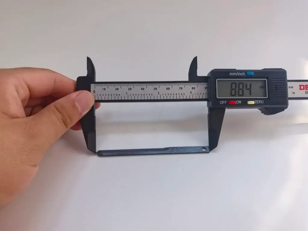 Measuring a cutter part with a digital caliper